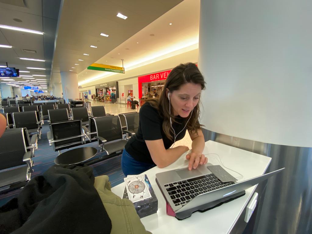 Carly taking a client call from an airport
