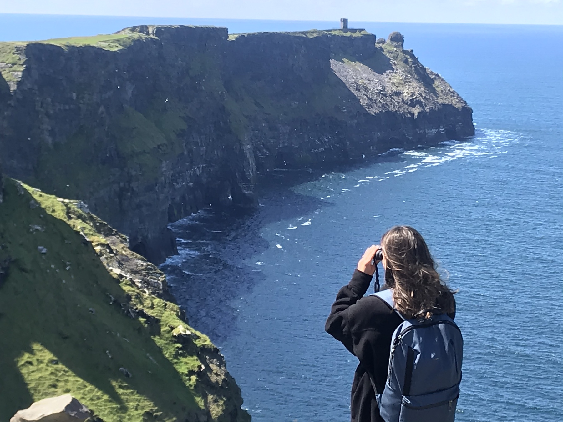 Carly photographing the Cliffs of Moher in Ireland