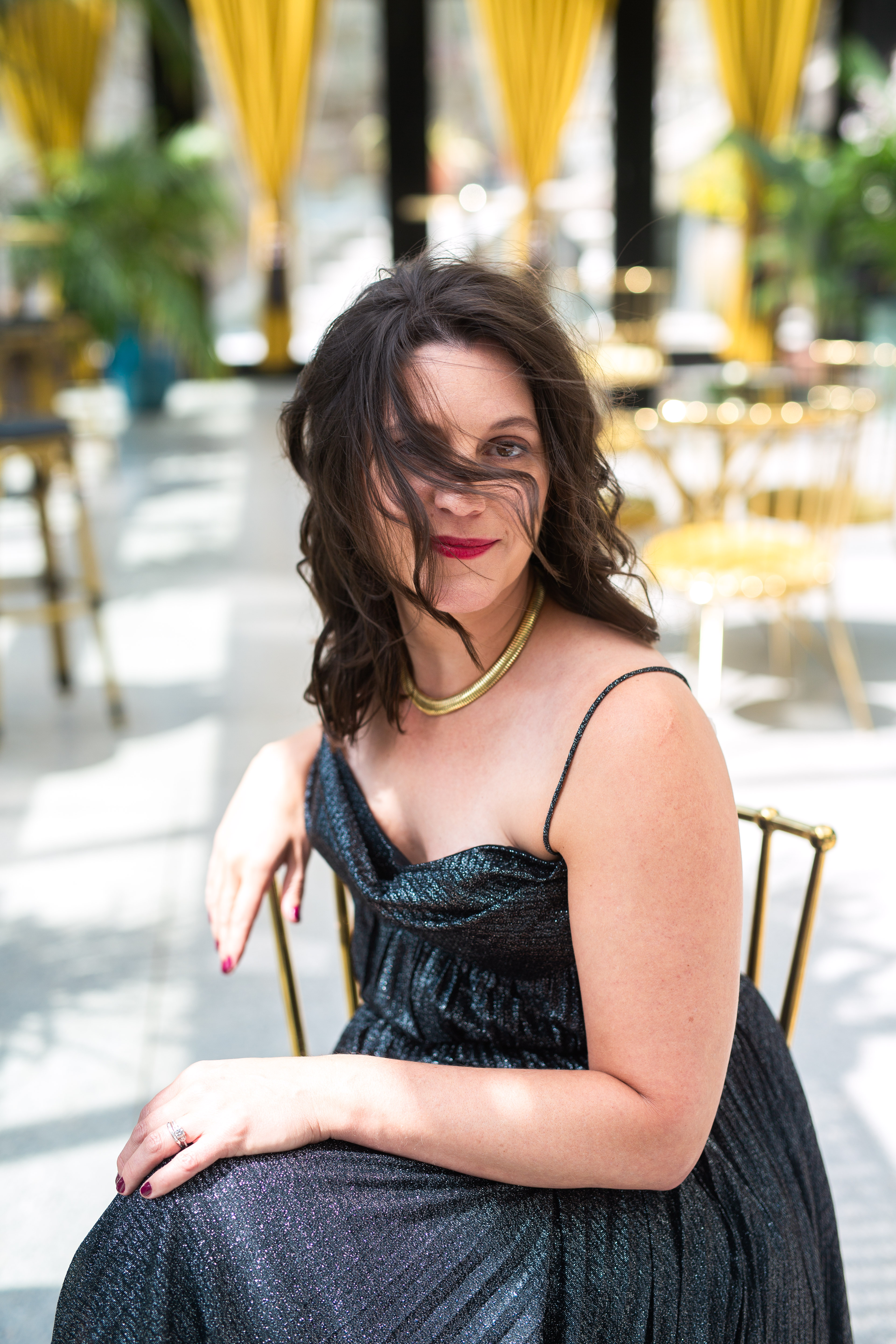 Carly Clark Zimmer seated in a shimmering black dress