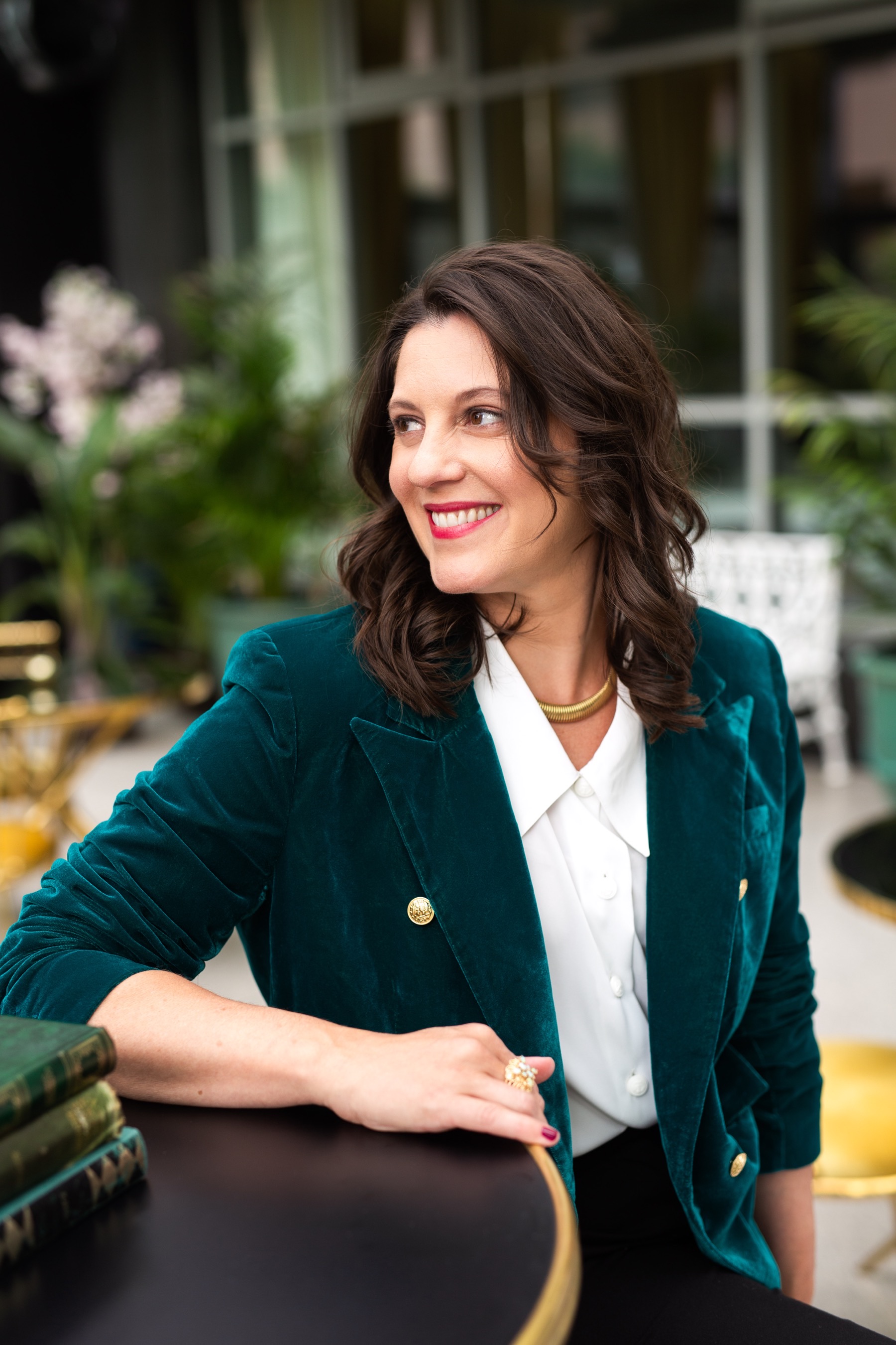Carly Clark Zimmer seated in a teal jacket